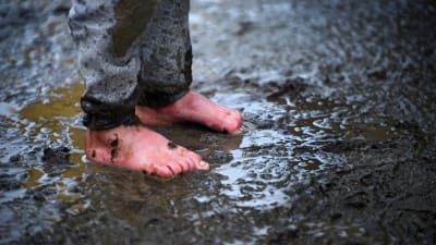 Fötter i lervällingen i Idomeni i Grekland.