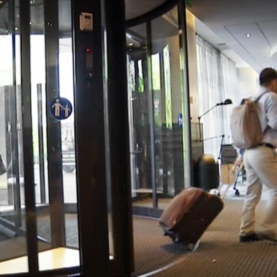 Turistit saapumassa hotellin aulaan Helsingissä.