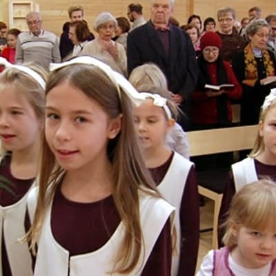 Lapset kirkossa palmunlehvät käsissään.