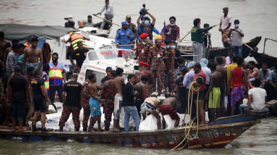 Människor på den båt försöker dra upp andra ur havet