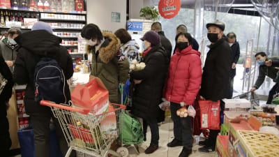 Invånare i Wuhan köar i en matbutik den 23 januari 2020.