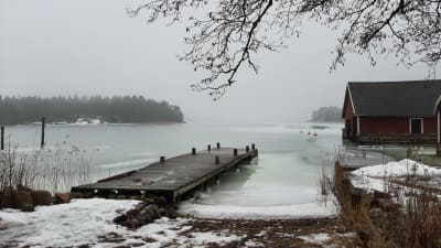 En brygga och båthus på Själö står i is, som håller på att ruttna och mjukna.