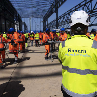 Työntekijöitä työasuissaan Tanskassa tehtaan rakennustyömaalla.