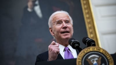 Joe Biden står vid ett podium och talar. 
