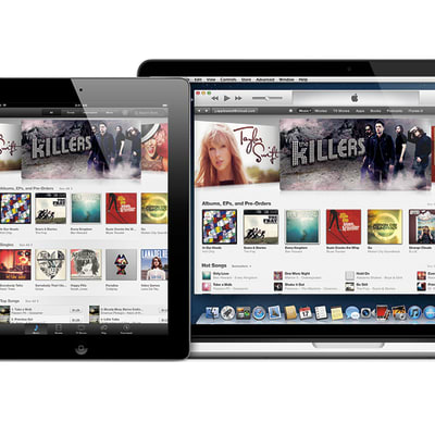 Taustalla kannettava Mac-tietokone, edessä vasemmalla iPad sekä oikealla iPhone. Kaikissa näytöissä näkyy iTunes-ohjelma.