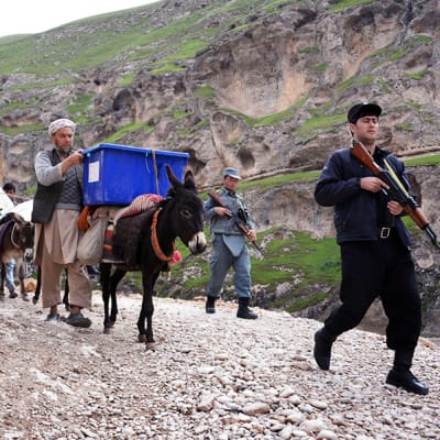 Vaalityöntekijät kuljettivat äänestykseen liittyvää materiaalia poliisin saattelemana Kishindih`n alueella Pohjois-Afganistanissa 3. maaliskuuta.