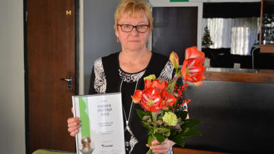 Seija Klemetti med diplom och blommor.