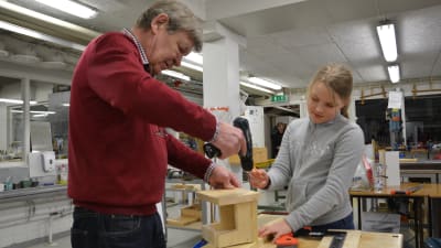 Kaj Fröberg och Alexandra Niemi bygger en fågelholk för en grå flugsnappare.