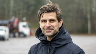 Niklas Nyman står utomhus på en parkering och tittar in i kameran.