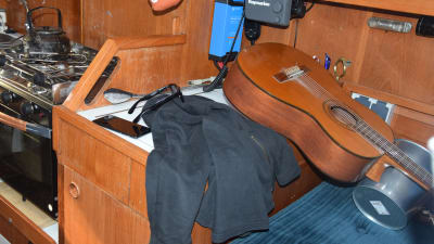 insidan av en segelbåt, med en huppari och en gitarr