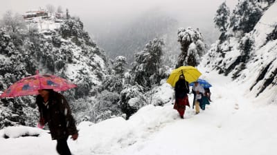 Ett gäng vandrar på snötäckt bergsstig i Neelum-dalen, i den pakistanska delen av Kashmir. 