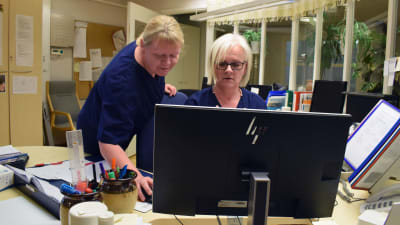 Päivi Granqvist och Carina Karlsson  ser över arbetsschemat vid datorn i Almahemmets kansli.