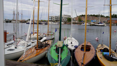 Klassiska segelbåtar i en hamn.