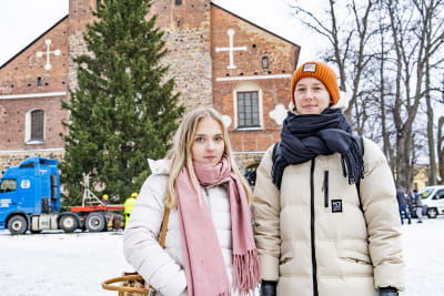 Två kvinnor står framför julgran.