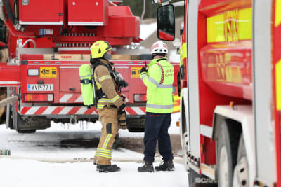 Brandmän vid en brandbil.