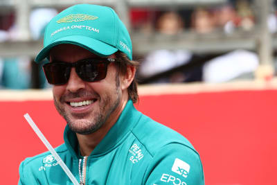 Fernando Alonso smiles up.