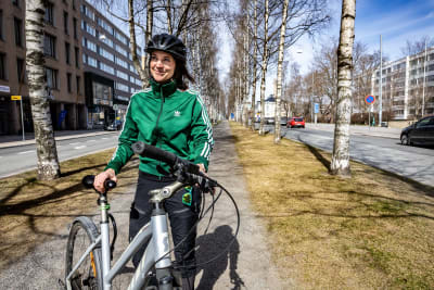Porträttfoto av kvinna i grön jacka och cykelhjälm