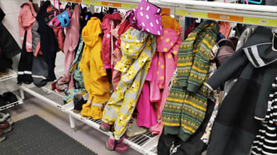 Barnens ytterkläder hänger i garderoben i S:t Karins svenska daghem.