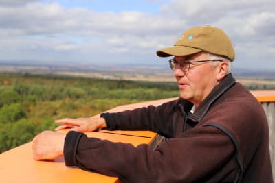 Manfred Grossman, en äldre man, blickar ut över skogar i Hainich.