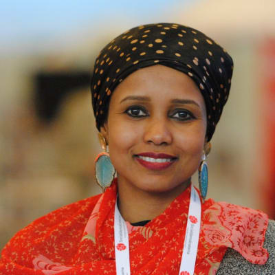 Saida Hussein Moge tittar in i kameran. Hon har röda kläder på sig.