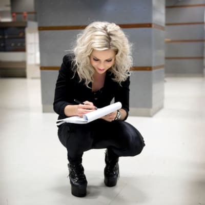 Krista Siegfrids jakaa nimikirjoituksia Yleisradion aulassa.