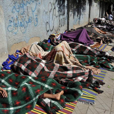 Eritreasta paenneet nukkuvat jalkakäytävällä odottaessaan apua YK:n pakolaisavulta Sanaassa, Jemenissä, toukokuussa 2014.