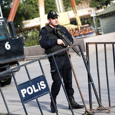 Aseistettu poliisi pommi-iskujen tapahtumapaikalla Ankarassa.