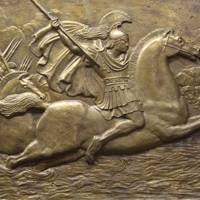 Reliefi, jossa keihästä heiluttava Aleksanteri Suuri johtaa joukkojaan hevosen selässä.