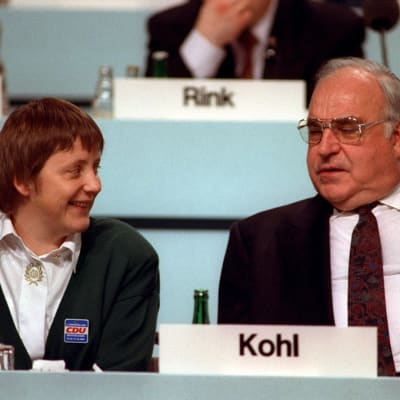 Angela Merkel ja Helmut Kohl puolilähikuvassa, Merkel hymyilee. 
