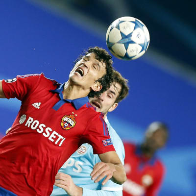 Davy Propper (R) of PSV Eindhoven in action against Roman Eremenko (L) of CSKA Moscow during the UEFA Champions League
