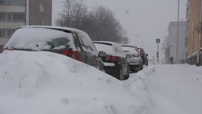 Bilar parkerade vid snövall