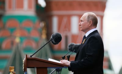 Rysslands president Vladimir Putin vid en talarstol på segerdagen 9 maj 2022. 