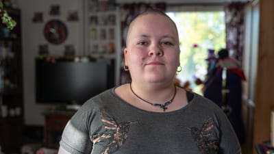 Porträttbild av Anja Viljanen stående i sitt vardagsrum. 