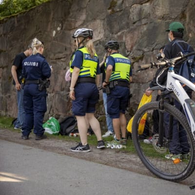 Cyklande poliser har stannat vid Sandudds badstrand för att prata med en skolavslutningsfirare.
