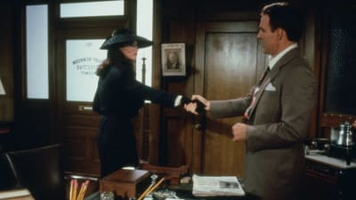 Mies (Steve Martin) pitelee tummahiuksisen naisen (Rachel Ward) ojennettua kättä 1940-lukulaisessa toimistohuoneessa.