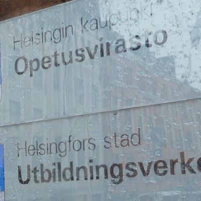 En regnvåt skylt där det står Helsingfors stad Utbildningsverket.