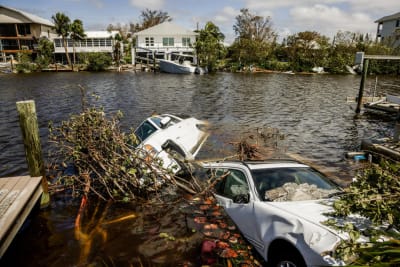 Bilar flyter omkring i översvämningar