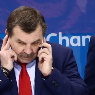 Ryske hockeytränaren Oleg Znarok pratar i telefon.