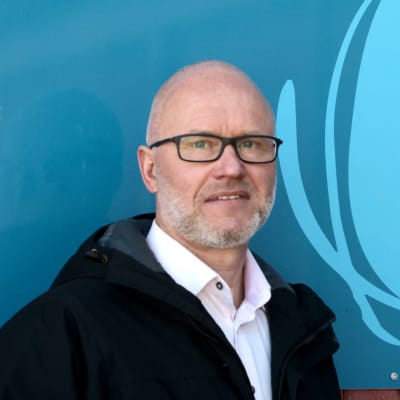 Utbildningschef Timo Tenhunen vid en skylt i Isnäs skola i Lovisa