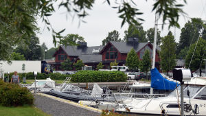 Många båtgäster skulle vilja bada bastu i gästhamnen. I dag finns det bara en bastu i ett privat gym i köpcentret Strand. Båtar står förtöjda i en småbåtshamn. I bakgrunden skymtar en stor röd byggnad med en skylt där det står Strand.