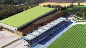 Idrottshallen ska placeras precis bredvid Alberga stadions läktare. Arkitektbild över ny idrottshall i Alberga, här ser man hur hallen ligger precis intill stadions läktare