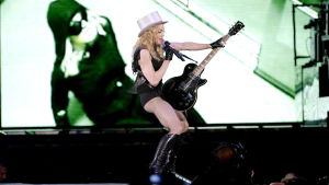 Madonna i Göteborg år 2009. Madonna på scenen i Göteborg år 2009 med elgitarr mellan benen som en fallossymbol.