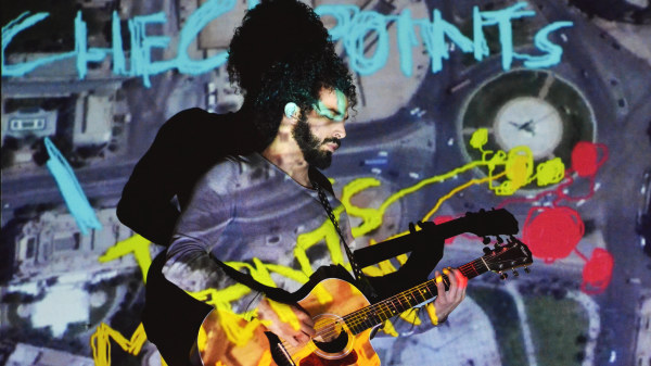 ramy plays guitar on his performance
