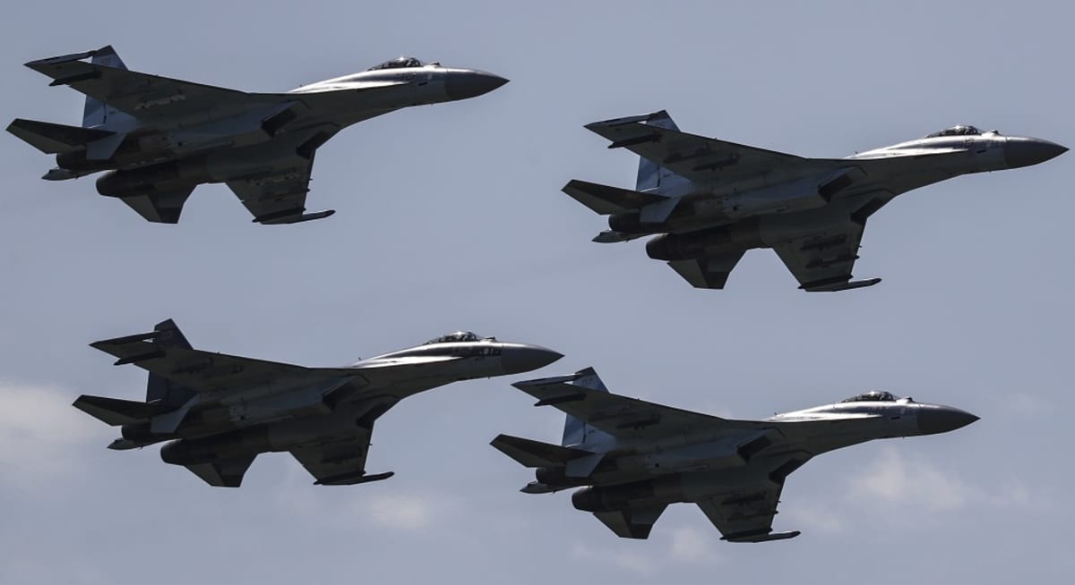 Neljä hävittäjää lentää muodostelmassa vasten sinistä taivasta.