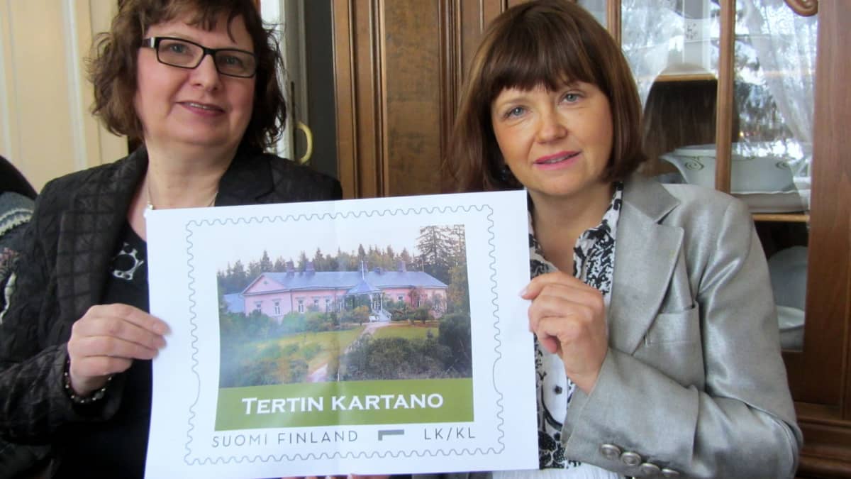 Mirja Pynnönen ja Pepita Pylkkänen esittelevät Tertin kartanon postimerkin suurennosta. 