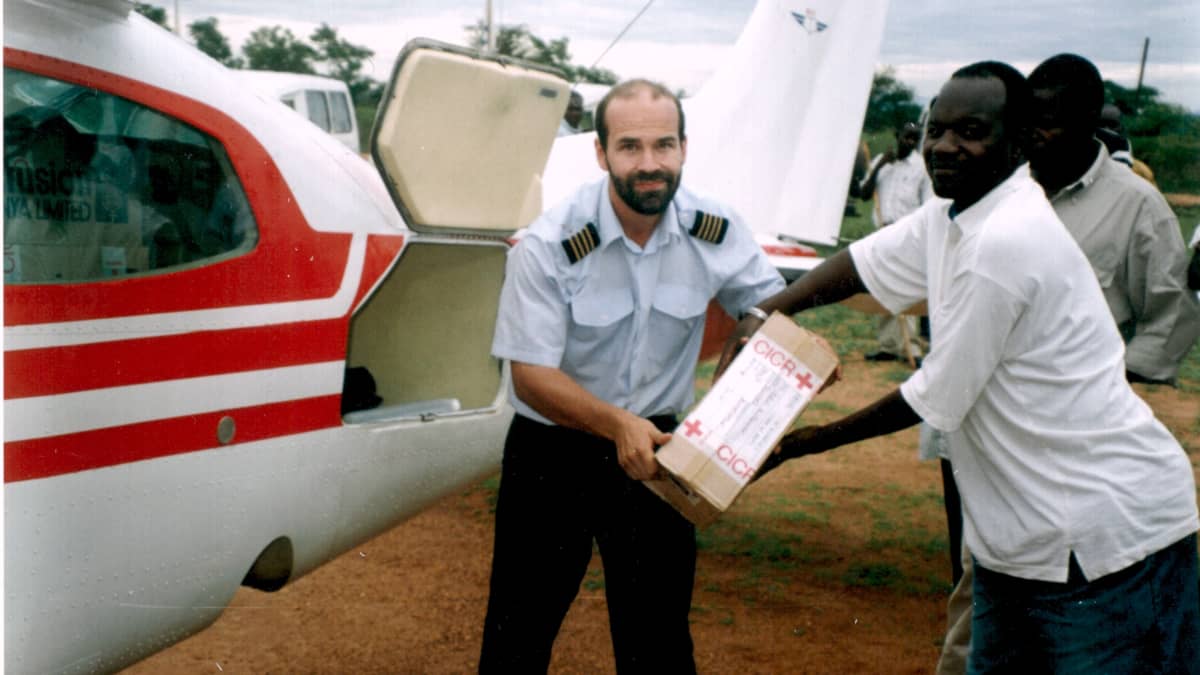Janne Ropponen purkaa rahtia lentokoneesta ugandalaisen miehen kanssa.
