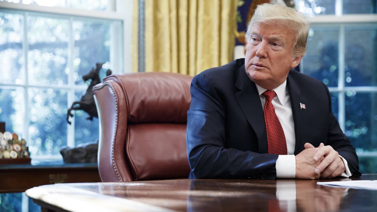 Yhdysvaltain presidentti Donald Trump istuu työpöytänsä takana.