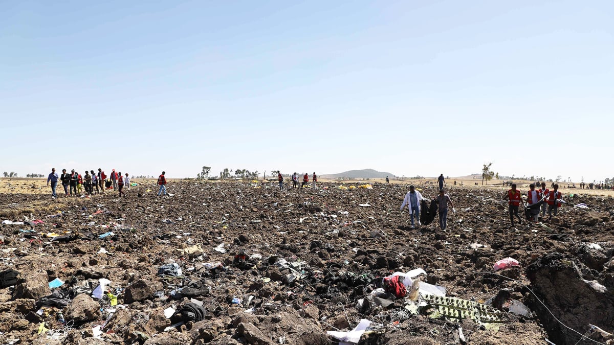Pelastusmiehistöt keräävät matkustajien ruumiita ja tavaroita onnettomuuspaikalla Etiopiassa.