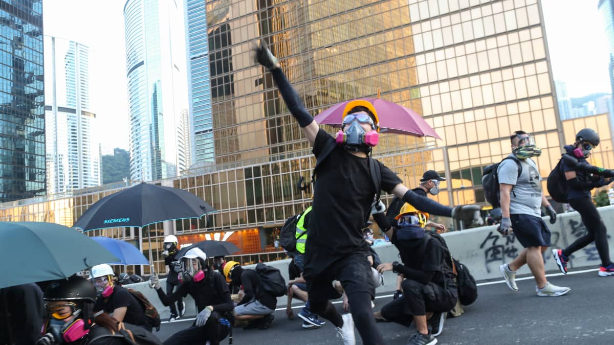 Mielenosoittajia kaasunaamareissa Hongkongin hallintokeskuksella