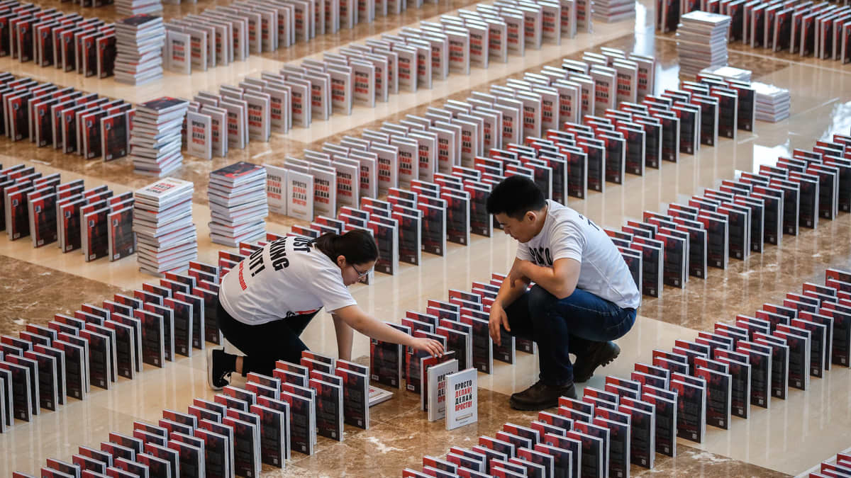  People install a domino books titled 'Just do it! Do it easy!' by German-Russian businessman Oskar Hartmann prior to attempt to set the book dominoes world record in Moscow, Russia, 14 February 2020. All 15,000 books toppled in the dominoes. 